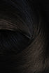 A close-up texture shot of dark, glossy hair with subtle warm brown undertones and a soft, swirled arrangement. (Jet Black / 