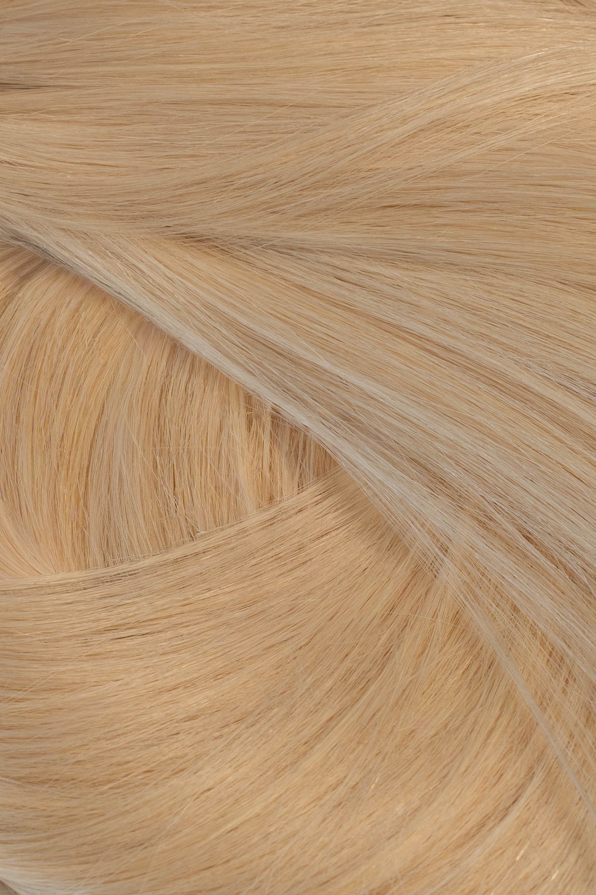 A close-up texture shot of light blonde hair, showing the fine strands and subtle golden-beige color variation. (Warm Blonde / #22)