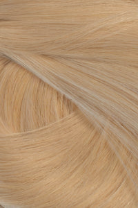 A close-up texture shot of light blonde hair, showing the fine strands and subtle golden-beige color variation. (Warm Blonde / #22)