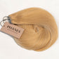 A bundle of straight blonde hair extensions with a beige paper tag reading PHANES HAIR EXTENSIONS, photographed on a clean white background. (California Blonde / #24)