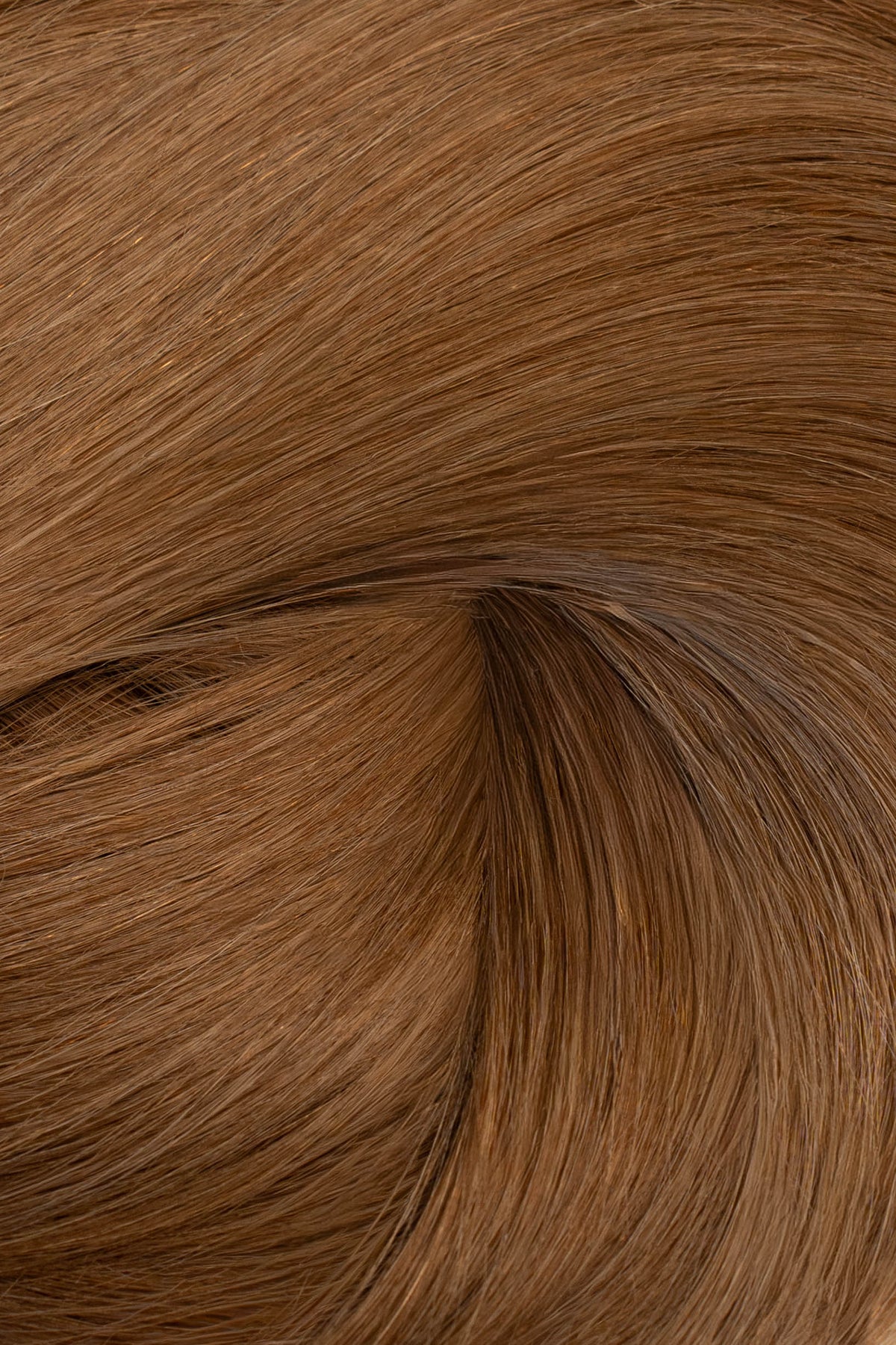 A close-up texture shot of straight, medium brown hair with a soft swirl pattern, showing the color and fiber detail. (Light Brown / #6)