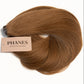 A bundle of PHANES clip-in hair extensions in a warm medium brown shade, with a beige paper label attached, set against a plain white background. (Light Brown / #6)