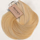 A bundle of blonde hair extensions with a beige paper tag reading PHANES, displayed on a clean white background. (Blondest Blonde / #60)