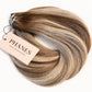 A bundle of Phanes hair extensions in a light brown and blonde ombré color, with a tan Phanes Hair Extensions tag attached, set against a plain white background. (Boston Balayage B2/60)