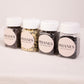 Four jars of Phanes on a light pink background