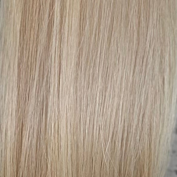A close-up texture shot of straight, light blonde hair, showing individual strands and a subtle warm golden-beige tone. (Pearl Blonde Highlights / #P18/60)