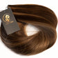 A bundle of medium brown hair extensions with a dark gray tag featuring a gold logo, set against a plain white background. (Toffee Bronde / #P2/6)