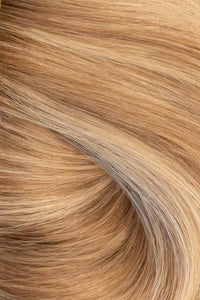 A close-up texture shot of wavy, light golden blonde hair with subtle warm brown and beige undertones. (Brooklyn Balayage / #TFF)