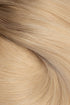 A close-up texture shot of light blonde hair with subtle warm brown lowlights, showing the fine strands and smooth flow of the hair. (Cool Ombré / 